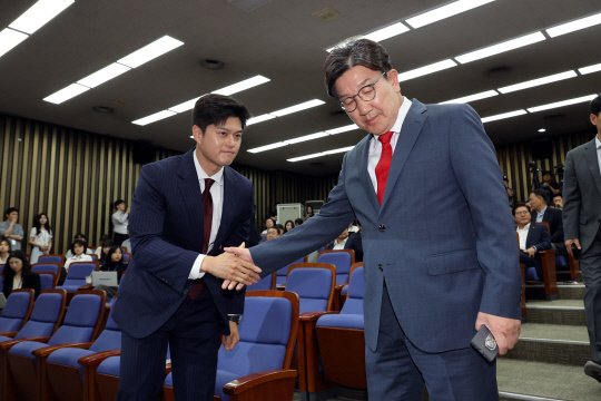김용태 국민의힘 비상대책위원장과 권성동 원내대표가 지난 9일 국회에서 열린 의원총회에서 악수한 뒤 각자의 자리로 향하고 있다. [연합뉴스]